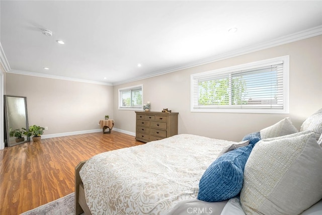 bedroom featuring wood finished floors, recessed lighting, ornamental molding, and baseboards