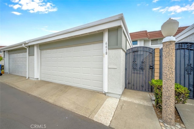 detached garage featuring a gate