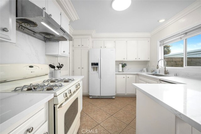 kitchen with a sink, under cabinet range hood, white appliances, crown molding, and light countertops
