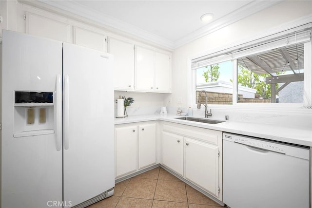 kitchen with white appliances, crown molding, white cabinets, and a sink