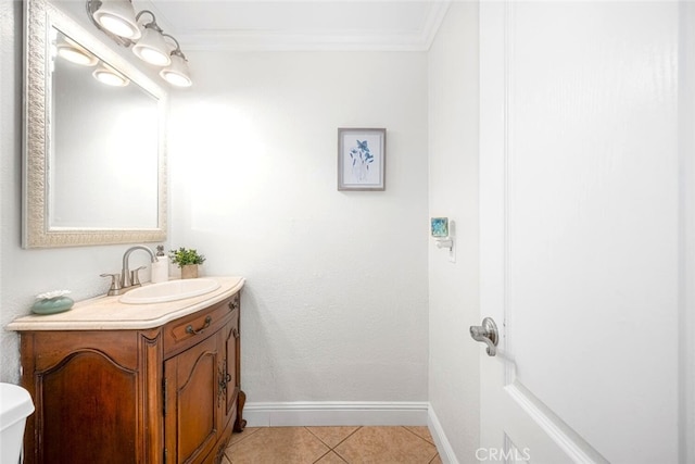 bathroom featuring ornamental molding, tile patterned floors, vanity, and baseboards