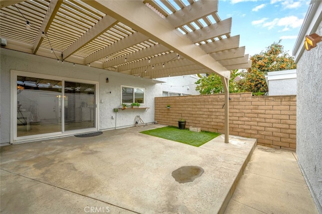 view of patio / terrace featuring fence and a pergola
