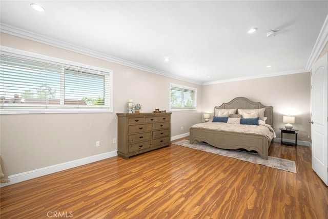 bedroom featuring wood finished floors, recessed lighting, ornamental molding, and baseboards