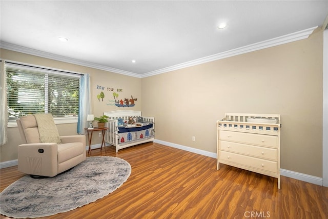 bedroom featuring ornamental molding, recessed lighting, wood finished floors, and baseboards