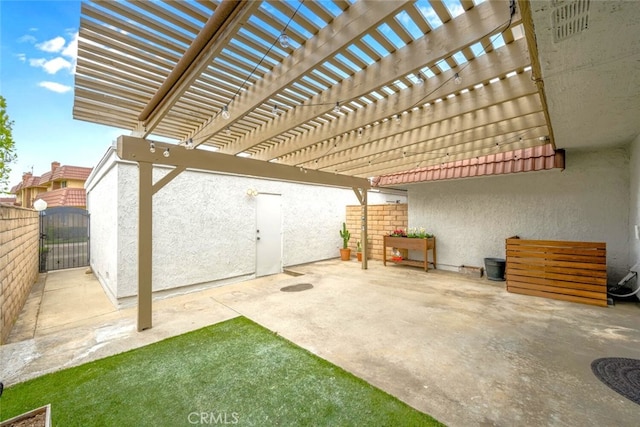 view of patio / terrace featuring a gate and fence