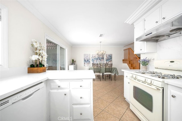 kitchen featuring under cabinet range hood, a notable chandelier, white appliances, crown molding, and light countertops