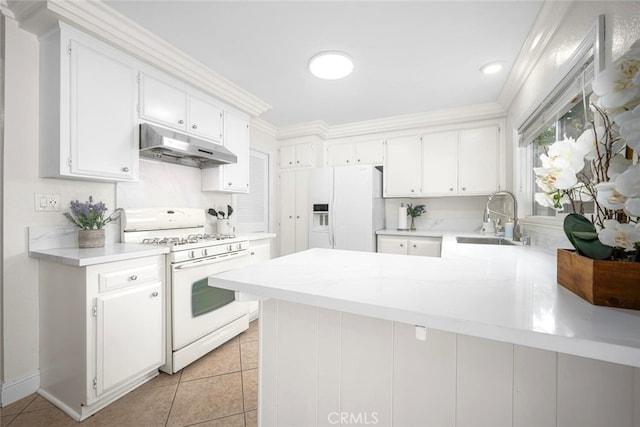 kitchen featuring a sink, white appliances, light countertops, and under cabinet range hood