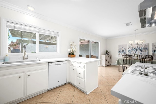 kitchen featuring a sink, a chandelier, dishwasher, ornamental molding, and a peninsula