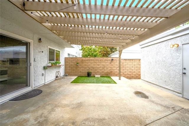 view of patio with a pergola and fence
