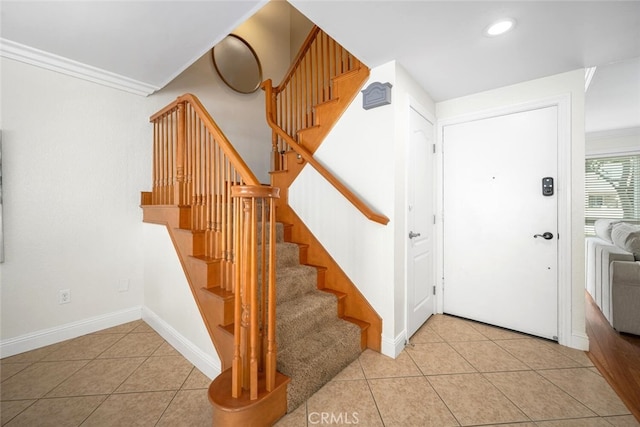 stairway with tile patterned floors, crown molding, recessed lighting, and baseboards