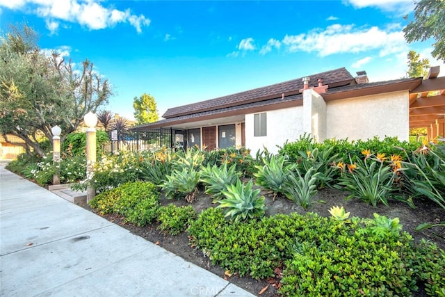 view of home's exterior featuring fence and stucco siding