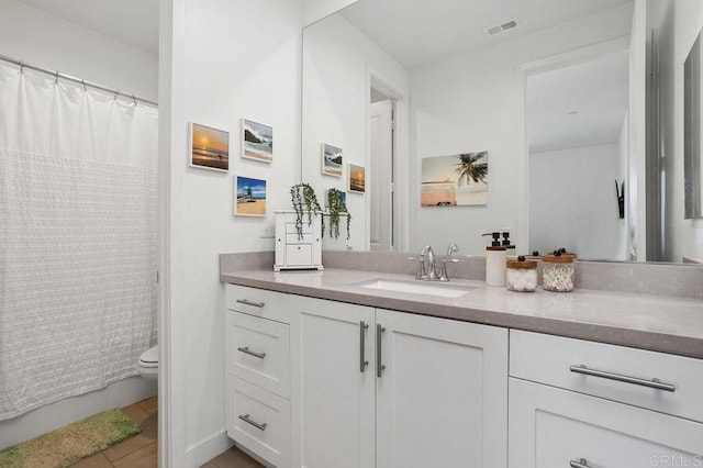 full bathroom featuring visible vents, a shower with shower curtain, toilet, vanity, and tile patterned flooring