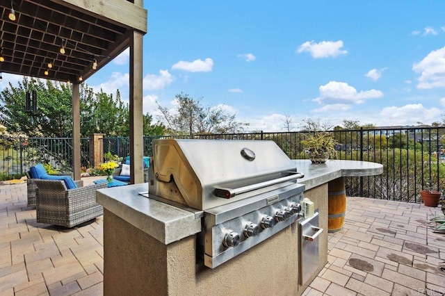 view of patio / terrace with fence, exterior kitchen, and area for grilling