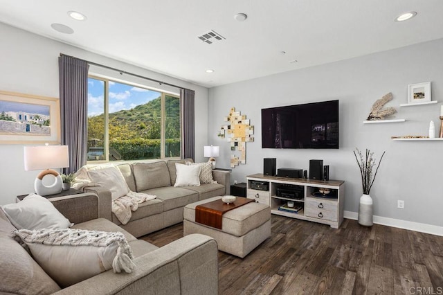 living area featuring recessed lighting, dark wood-style flooring, visible vents, and baseboards