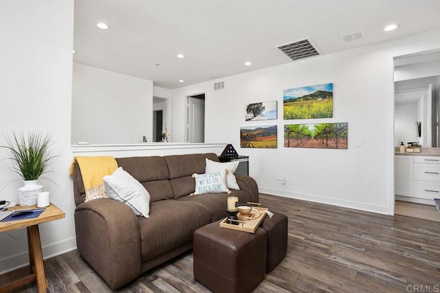 living area with visible vents, wood finished floors, and recessed lighting