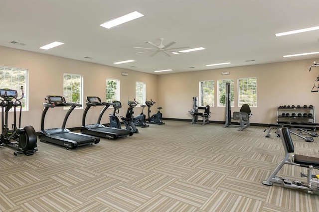 workout area featuring carpet floors, visible vents, and a healthy amount of sunlight