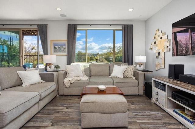 living room with dark wood finished floors, a wealth of natural light, and recessed lighting