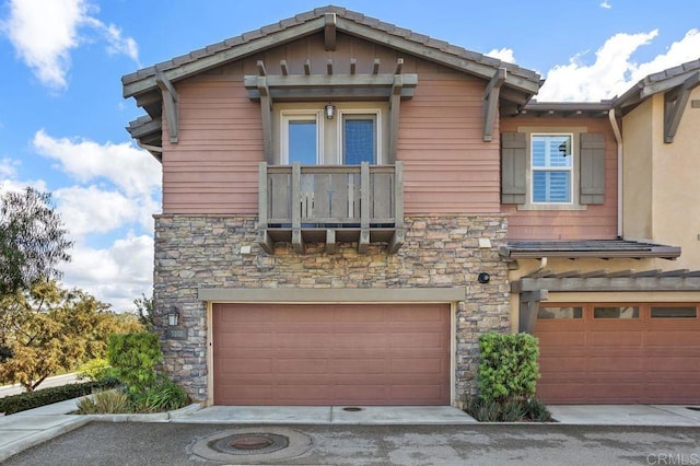 exterior space featuring stone siding and an attached garage