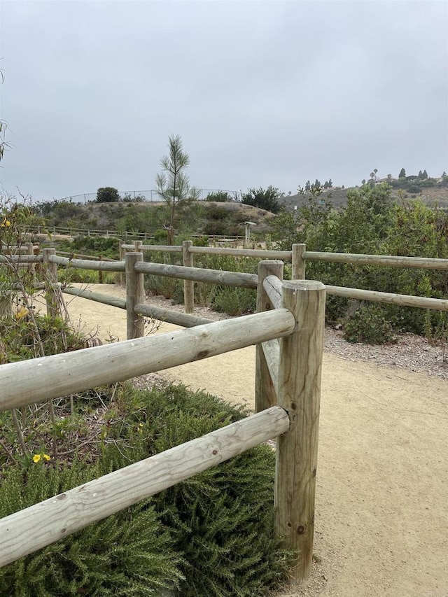 exterior space with fence and a rural view