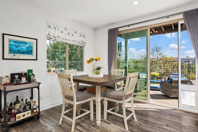 dining area with a healthy amount of sunlight, baseboards, wood finished floors, and recessed lighting