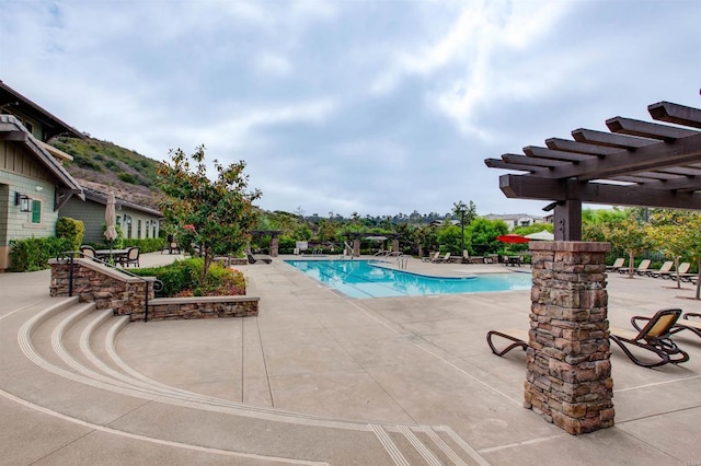 community pool featuring a patio and a pergola