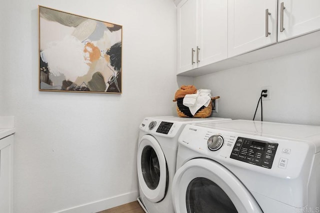 laundry room featuring cabinet space, baseboards, and washing machine and clothes dryer