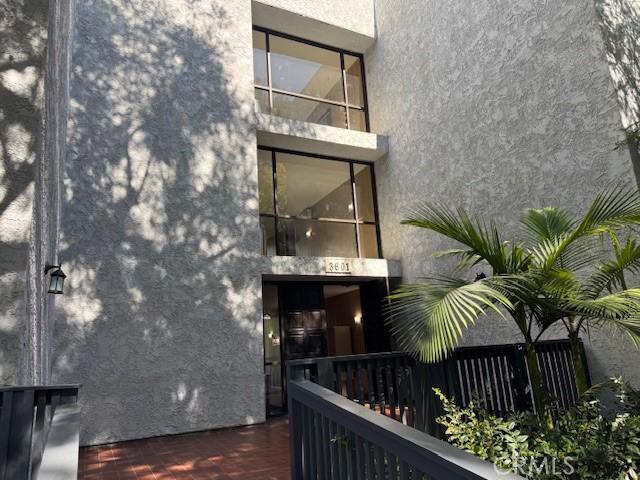 3601 W Hidden Ln Unit 309, Rolling Hills Estates, CA 90274 - rear view of house with stucco siding and a balcony