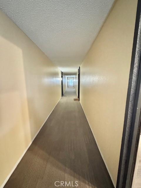 3601 W Hidden Ln Unit 309, Rolling Hills Estates, CA 90274 - hallway with a textured ceiling and carpet flooring