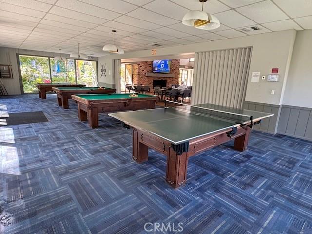 3601 W Hidden Ln Unit 309, Rolling Hills Estates, CA 90274 - recreation room featuring carpet, billiards table, a fireplace, a drop ceiling, and wainscoting