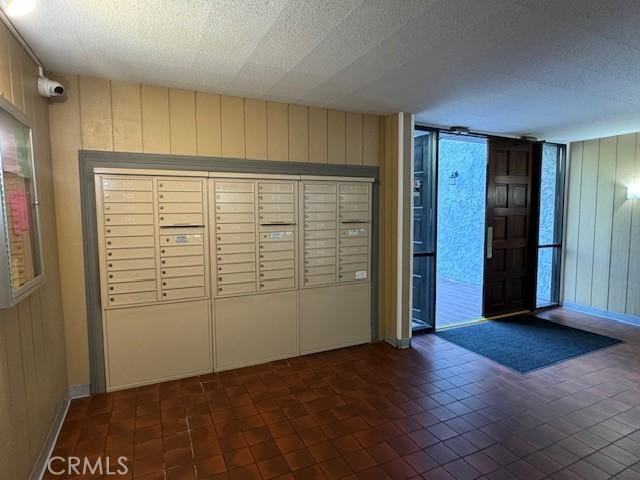 3601 W Hidden Ln Unit 309, Rolling Hills Estates, CA 90274 - view of community featuring mail area, wood walls, and a textured ceiling