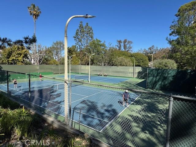 view of sport court featuring fence