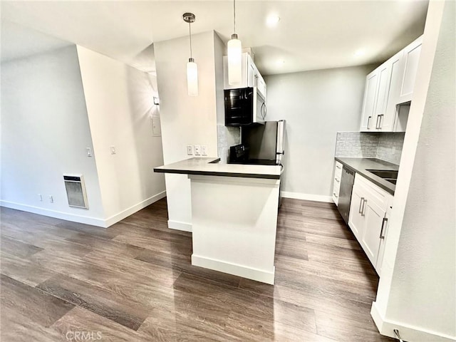 kitchen featuring dark wood-type flooring, tasteful backsplash, stainless steel appliances, white cabinets, and baseboards