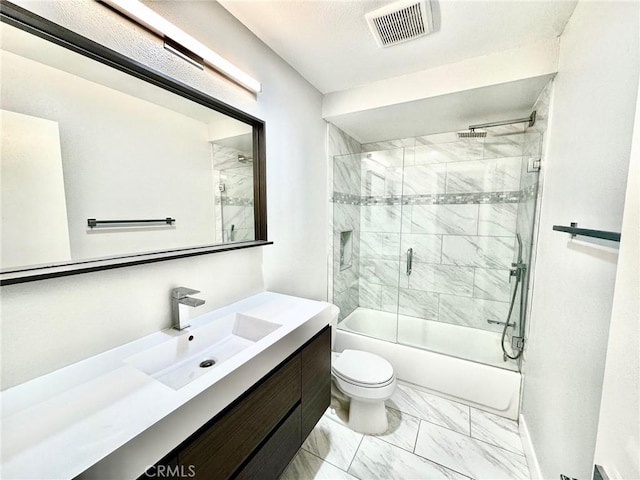 bathroom with visible vents, bath / shower combo with glass door, toilet, marble finish floor, and vanity