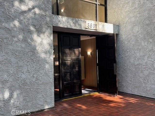 view of exterior entry with stucco siding