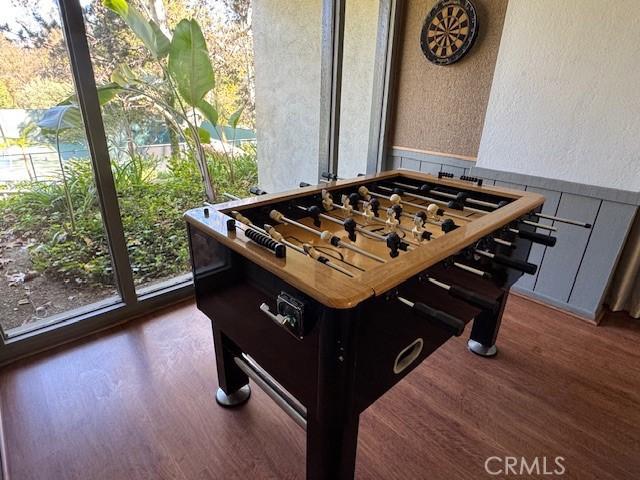 3601 W Hidden Ln Unit 309, Rolling Hills Estates, CA 90274 - game room featuring wood finished floors, wainscoting, and a textured wall