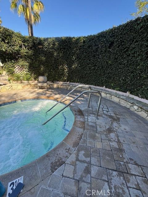 3601 W Hidden Ln Unit 309, Rolling Hills Estates, CA 90274 - view of pool with a swimming pool and a patio
