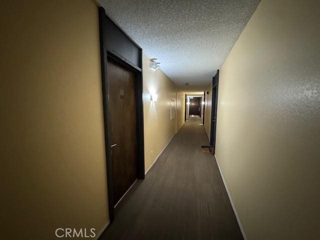 3601 W Hidden Ln Unit 309, Rolling Hills Estates, CA 90274 - hall with baseboards, a textured ceiling, and dark wood-type flooring