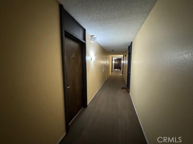 3601 W Hidden Ln Unit 309, Rolling Hills Estates, CA 90274 - corridor with a textured ceiling and dark wood-style floors
