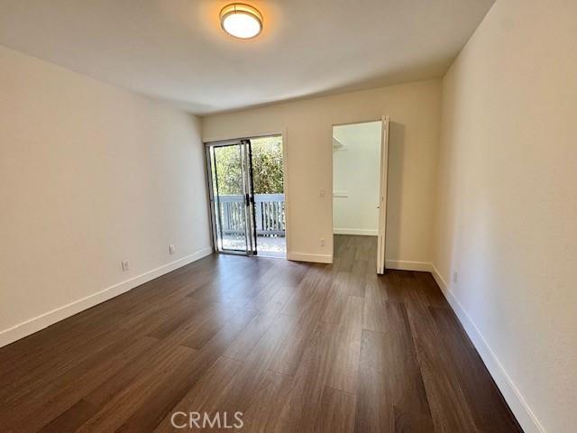 3601 W Hidden Ln Unit 309, Rolling Hills Estates, CA 90274 - spare room with dark wood-style flooring and baseboards