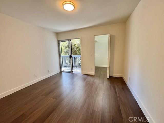 3601 W Hidden Ln Unit 309, Rolling Hills Estates, CA 90274 - spare room with dark wood-style flooring and baseboards