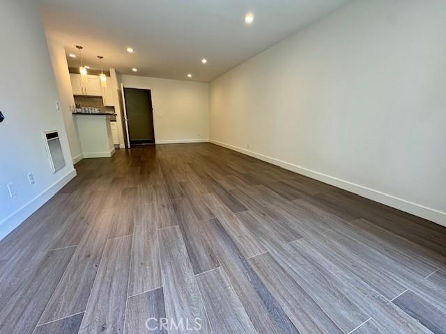 3601 W Hidden Ln Unit 309, Rolling Hills Estates, CA 90274 - unfurnished living room with dark wood-type flooring and recessed lighting