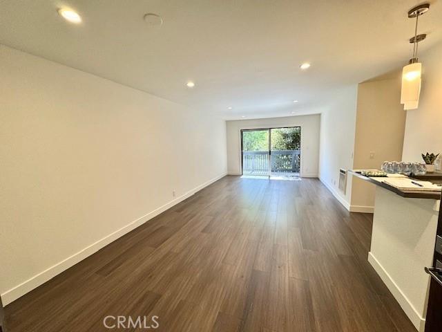 3601 W Hidden Ln Unit 309, Rolling Hills Estates, CA 90274 - unfurnished living room with dark wood-style floors, baseboards, and recessed lighting