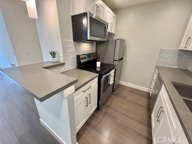 3601 W Hidden Ln Unit 309, Rolling Hills Estates, CA 90274 - kitchen featuring stainless steel appliances, backsplash, white cabinets, and dark wood finished floors