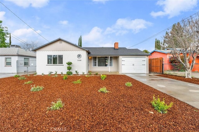 ranch-style house featuring driveway, an attached garage, a chimney, and fence