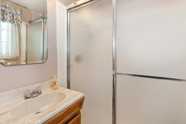 bathroom with a stall shower and vanity