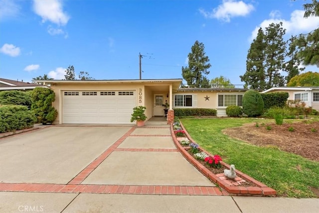 ranch-style home with a garage, driveway, and stucco siding