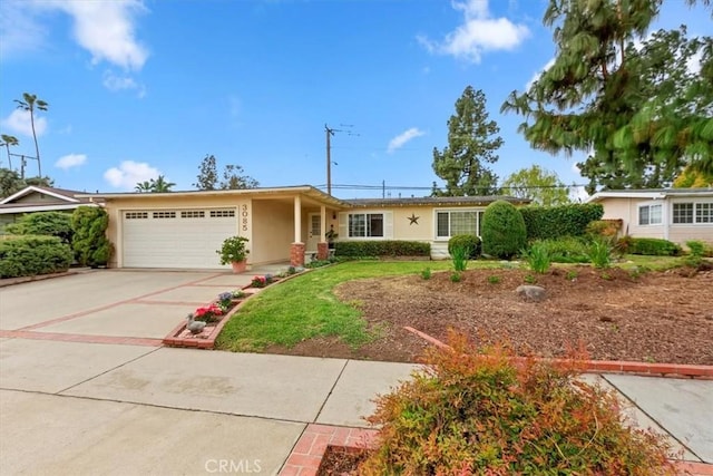 ranch-style house with an attached garage, driveway, and stucco siding