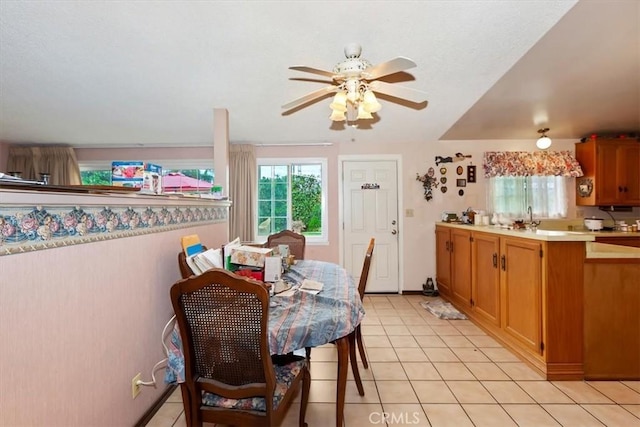 dining space featuring light tile patterned flooring and a ceiling fan