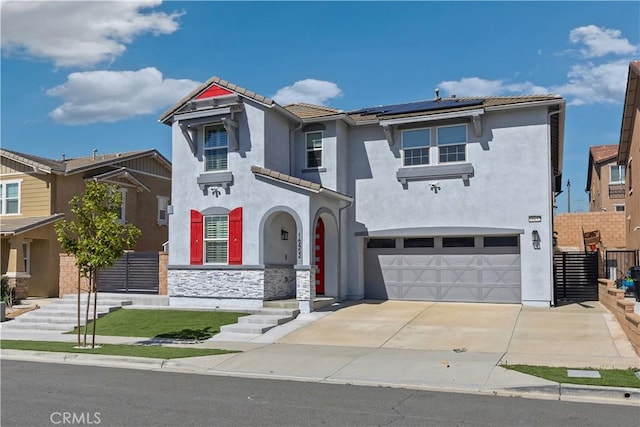 view of front facade with concrete driveway, solar panels, a tiled roof, an attached garage, and stucco siding