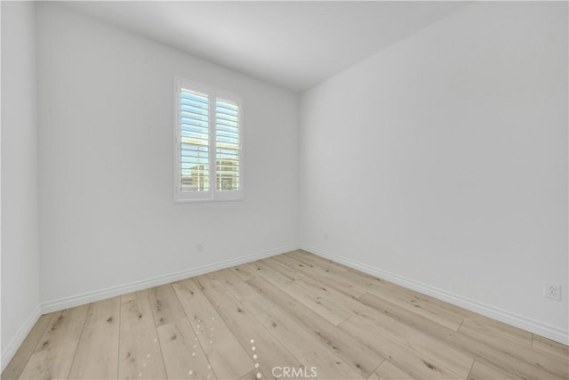 unfurnished room featuring wood finished floors and baseboards